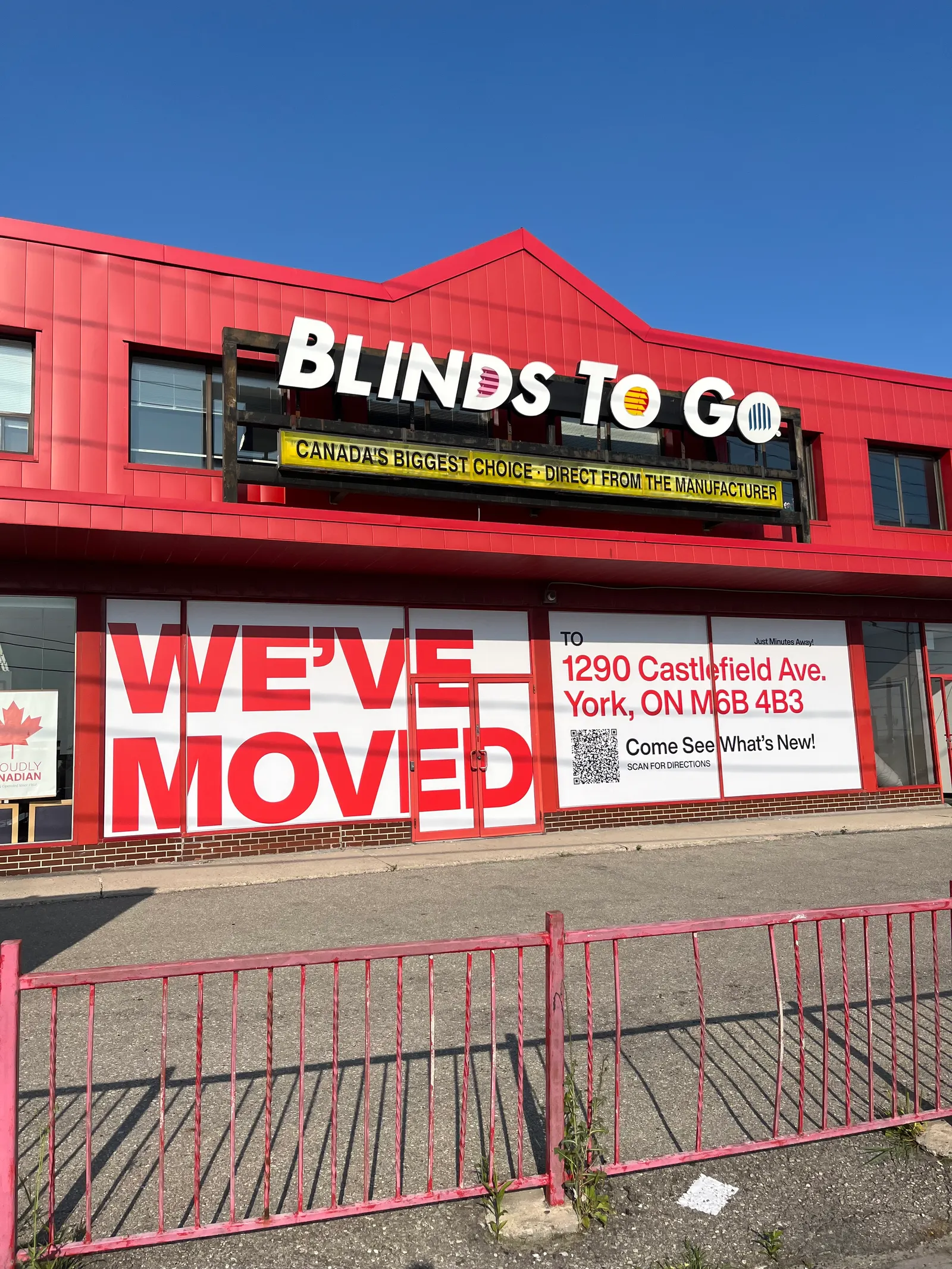 The original Blinds To Go location displays a We've Moved message on its window signage directing customers to a new address.