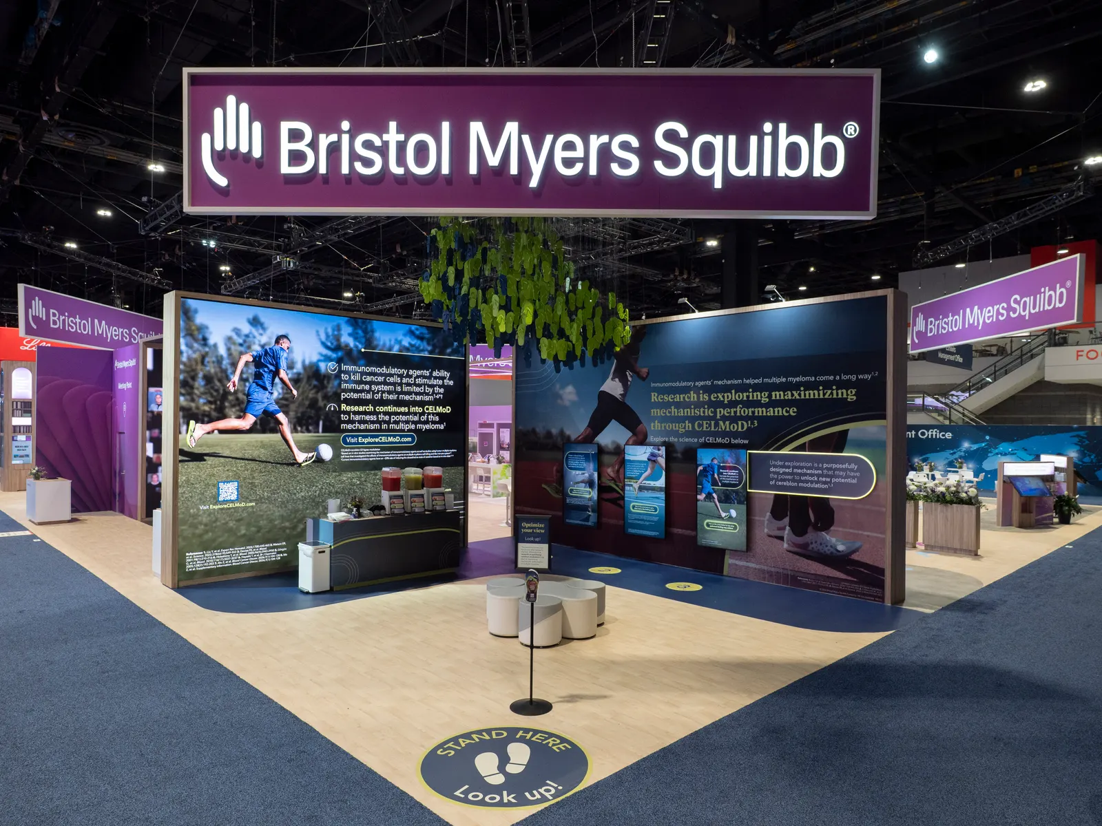 A Bristol Myers Squibb pharmaceutical trade show booth features CELMoD multiple myeloma research displays at a medical conference.